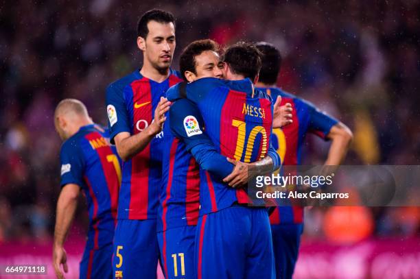 Lionel Messi of FC Barcelona celebrates with his teammates Neymar Santos Jr and Sergio Busquets after scoring his team's third goal during the La...