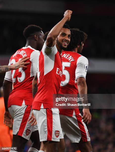 Theo Walcott of Arsenal celebrates scoring his sides second goal during the Premier League match between Arsenal and West Ham United at the Emirates...