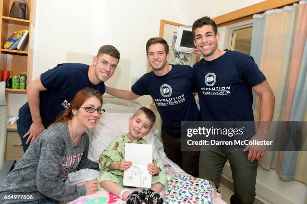 New England Revolution's Donnie Smith, Kelyn Rowe, and Joshua Smith, visit Logan at Boston Children's Hospital April 5, 2017 in Boston, Massachusetts.