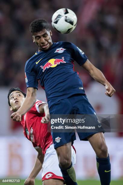 Bernado of Leipzig jumps for a header with Yoshinori Muto of Mainz during the Bundesliga match between 1. FSV Mainz 05 and RB Leipzig at Opel Arena...