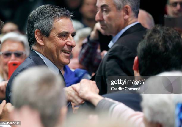 Former French prime minister and French presidential election candidate for the right-wing "Les Republicains" political party Francois Fillon shakes...