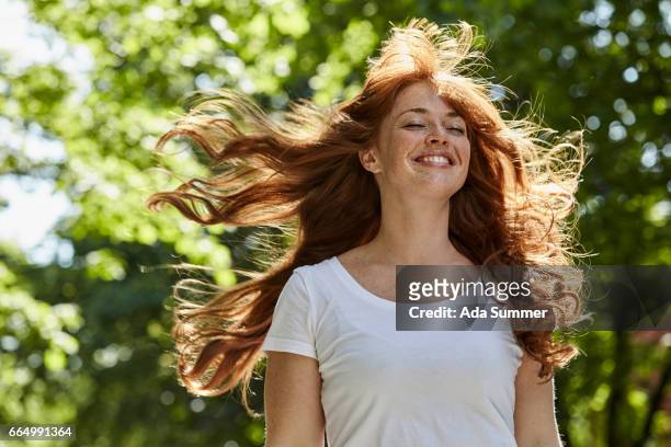 redhead enjoying the first rays of sun - beautiful redhead photos et images de collection
