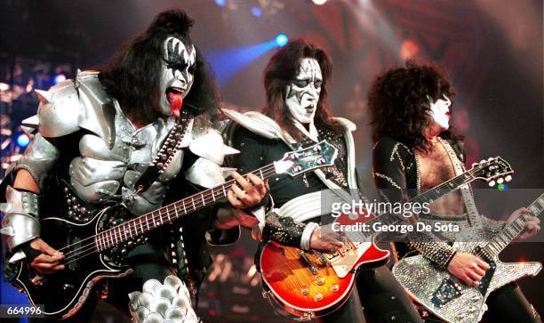 Bass player Gene Simmons, lead guitarist Ace Frehley, and rhythm guitarist and vocalist Paul Stanley of the rock group ''KISS'' perform live, June...