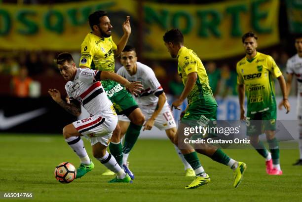 Julio Buffarini of Sao Paulo and Jonas Gutierrez of Defensa y Justicia fight for the ball during a first leg match between Defensa y Justicia and Sao...