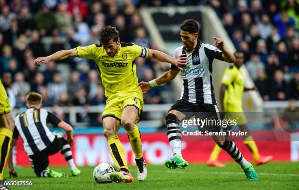 Ayoze Perez of Newcastle United looks to challenge John Mousinho of Burton Albion for the ball during the Sky Bet Championship Match between...