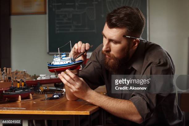 giovane che costruisce un modello di nave - scatola di montaggio foto e immagini stock