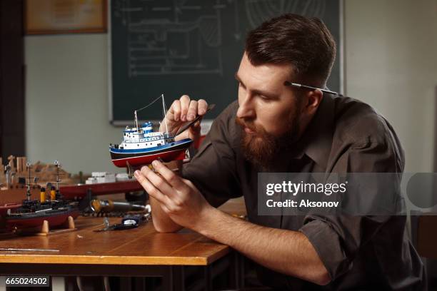 young man constructing a ship model - model kit stock pictures, royalty-free photos & images