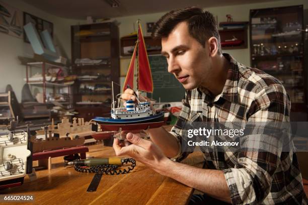 young man constructing a ship model - model kit stock pictures, royalty-free photos & images