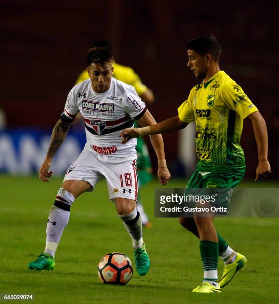Julio Buffarini of Sao Paulo fights for the ball during a first leg match between Defensa y Justicia and Sao Paulo as part of of first round of Copa...