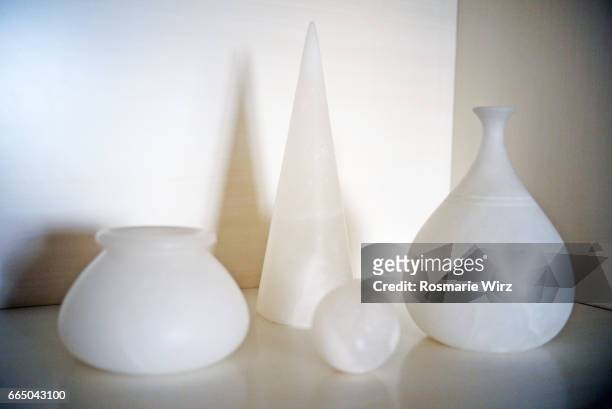 still life: four alabaster objects on white background - alabaster stockfoto's en -beelden