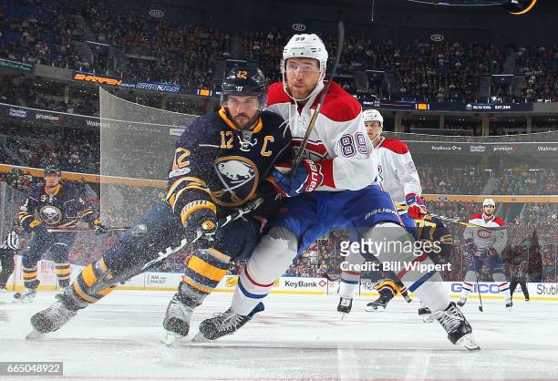 Brian Gionta of the Buffalo Sabres and Nikita Nesterov of the Montreal Canadiens battle for the puck during an NHL game at the KeyBank Center on...