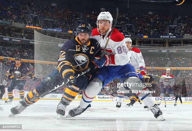 Brian Gionta of the Buffalo Sabres and Nikita Nesterov of the Montreal Canadiens battle for the puck during an NHL game at the KeyBank Center on...