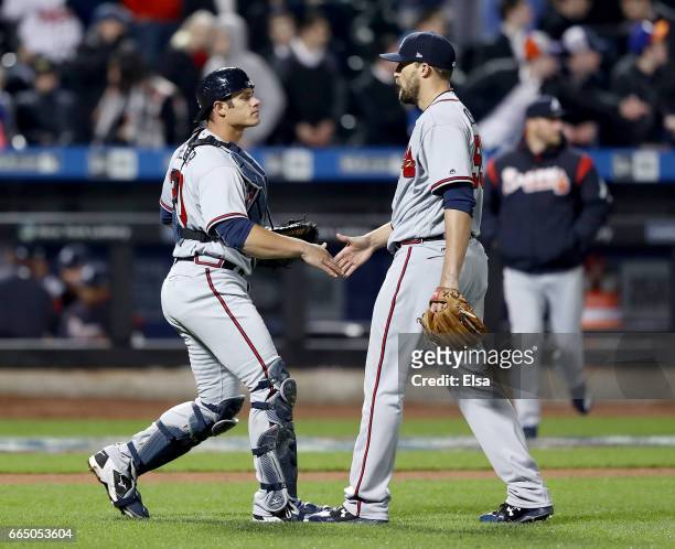 Anthony Recker and Jim Johnson of the Atlanta Braves celebrate the 3-1 win over the New York Mets in the 12th inning on April 5, 2017 at Citi Field...