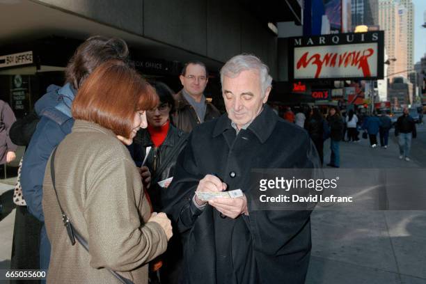 French singer Charles Aznavour signs autographs outside the Marquis in New York during a series of performances there.