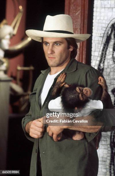 French actor Gerard Depardieu holds a young chimpanzee on the set of film Ciao Maschio, , directed by Italian director Marco Ferreri.