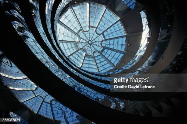 The glass dome of the coil spiral gallery permits natural light to play a predominant role in the Guggenheim Museum, designed by architect Frank...