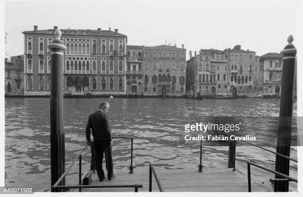 Director Michelangelo Antonioni stands by the Grand Canal, with the city of Venice in the background, on the set of his movie Identificazione di una...