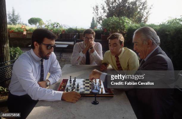Anthony Quinn plays chess with son Francesco, while younger sons Danny and Lorenzo look on, at their house near Rome.