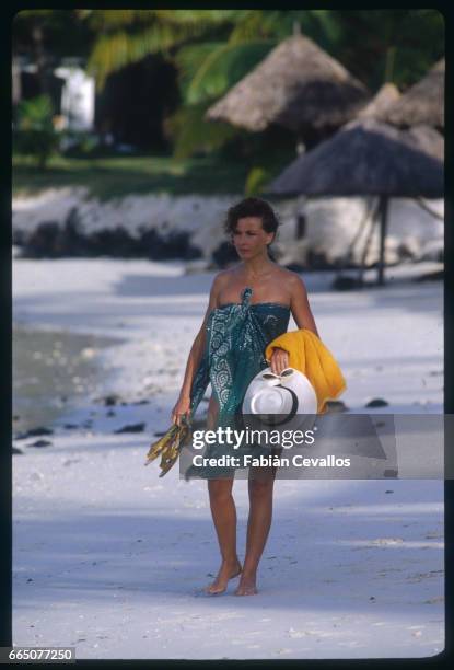Marlene Jobert walks along the beach while on vacation in Mauritius.