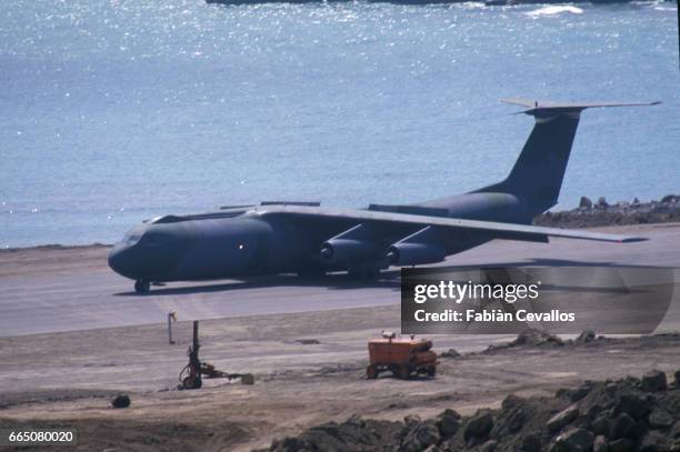 Cargo plane, without roundel and registration, lands at Point-Salines Airport. 1900 US army soldiers and 300 soldiers from Barbados and Antigua,...