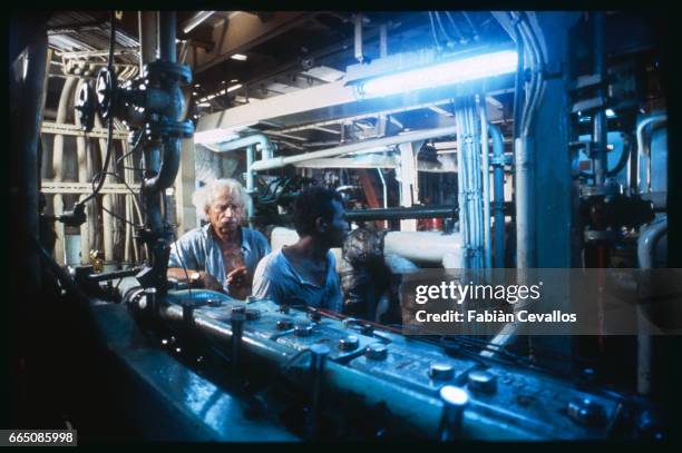 The American actor Samuel Fuller and crew members in the engine room of a ship during the shooting of the 1988 French TV series Medecins des Hommes...