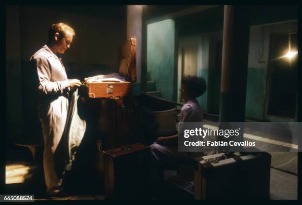 American actors John Malkovitch and Debra Winger unpack in their room, during the shooting of the movie Un The au Sahara, or Il Te Nel Deserto,...