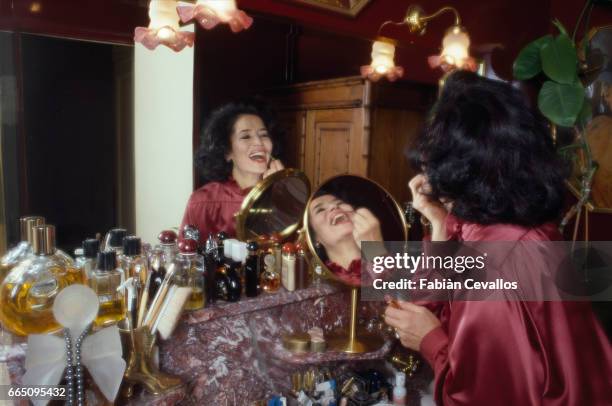 French Actress Marie-Jose Nat, at home doing her make-up.