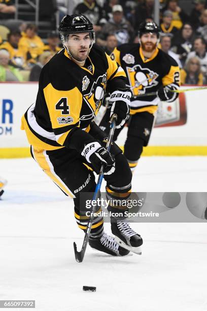 Pittsburgh Penguins Defenseman Justin Schultz skates the puck out of the defensive zone during the first period in the NHL game between the...