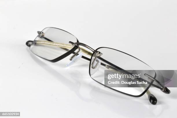 a pair of reading glasses - monocle stock pictures, royalty-free photos & images