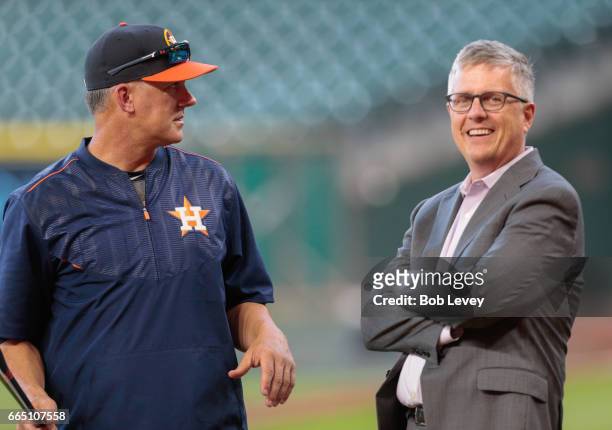Manager A.J. Hitch of the Houston Astros and general manager Jeff Luhnow talk during batting practice at Minute Maid Park on April 4, 2017 in...