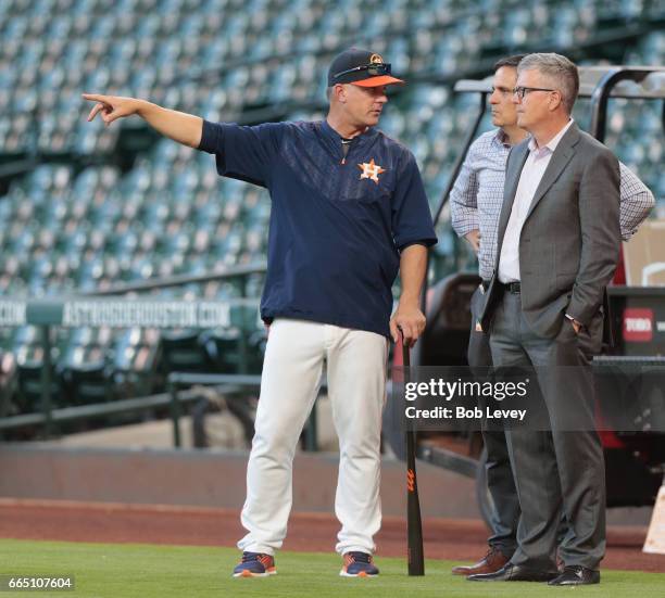Manager A.J. Hitch of the Houston Astros and general manager Jeff Luhnow talk during batting practice at Minute Maid Park on April 4, 2017 in...