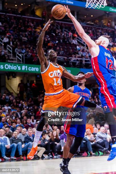 DeAndre Liggins of the Cleveland Cavaliers shoots while under pressure from Aron Baynes of the Detroit Pistons during the second half at Quicken...