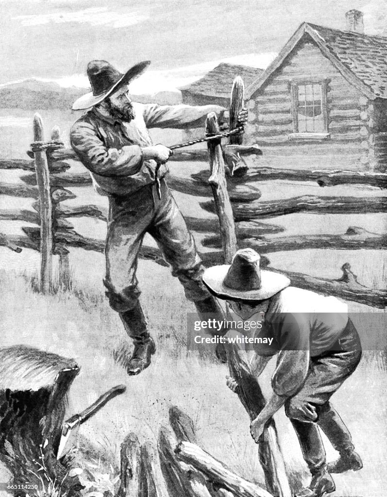 Nineteenth century American father and son putting up a fence