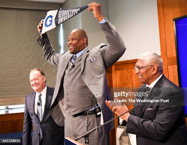 Patrick Ewing recreates the photograph of when he signed as a player during the press conference where he is introduced as the new head coach of the...