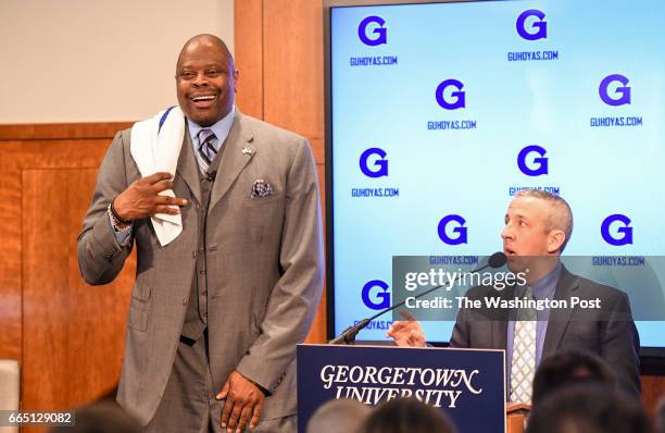 Georgetown Head Coach Patrick Ewing playfully flips a towel over his shoulder like the signature towel used by his coach, John Thompson, Jr. During...