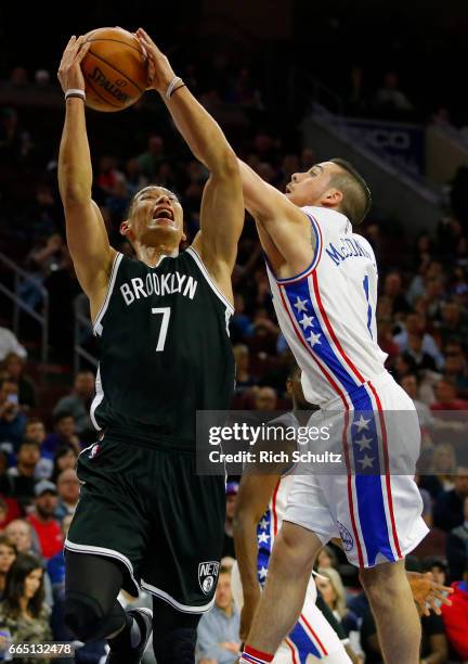 Jeremy Lin of the Brooklyn Nets attempts a shot as T.J. McConnell of the Philadelphia 76ers defends in the first half during an NBA game at Wells...