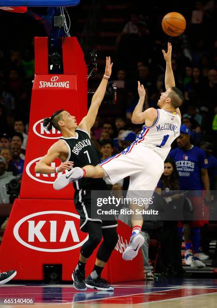 McConnell of the Philadelphia 76ers attempts a shot as Jeremy Lin of the Brooklyn Nets defends in the first half during an NBA game at Wells Fargo...