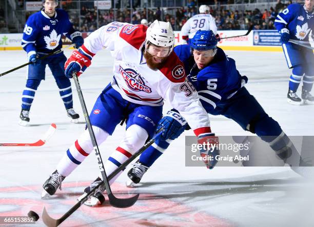 Anthony Camara of the St. John's IceCaps battles for the puck with Steven Oleksy of the Toronto Marlies during AHL game action on April 4, 2017 at...