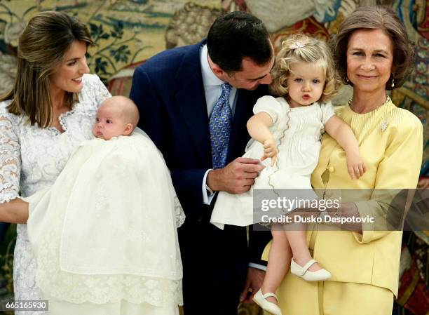 Spain's Princess Letizia holds her second daughter, Princess Sofia, as Crown Prince Felipe de Borbon talks with their first daughter, Princess...