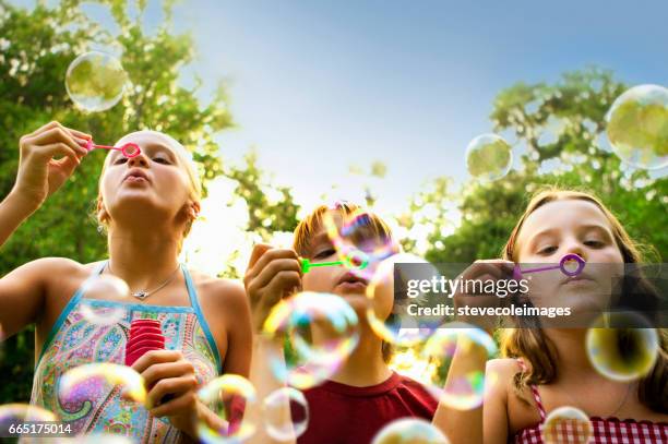 bellen blazen - child blowing bubbles stockfoto's en -beelden