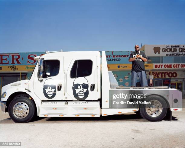 Rick Ross stands on the bed of his customized Freightliner.