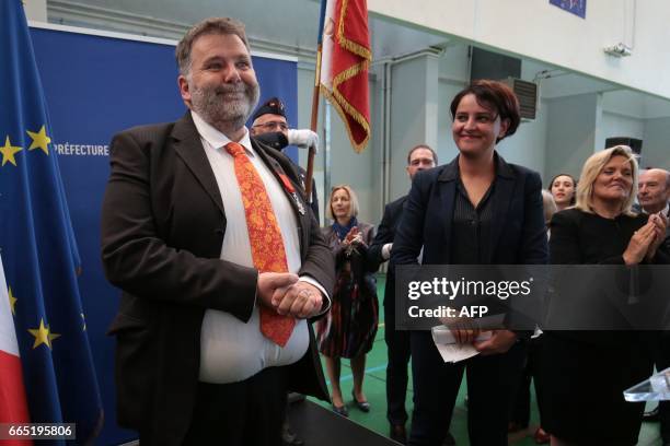 Herve Pizzinat , head teacher of the Alexis de Tocqueville high school, smiles next to French Education Minister Najat Vallaud-Belkacem after being...