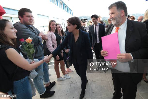 Herve Pizzinat , head teacher of the Alexis de Tocqueville high school, looks on as French Education Minister Najat Vallaud-Belkacem greets students...