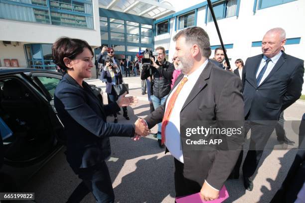 Herve Pizzinat , head teacher of the Alexis de Tocqueville high school, shakes hands with French Education Minister Najat Vallaud-Belkacem as she...