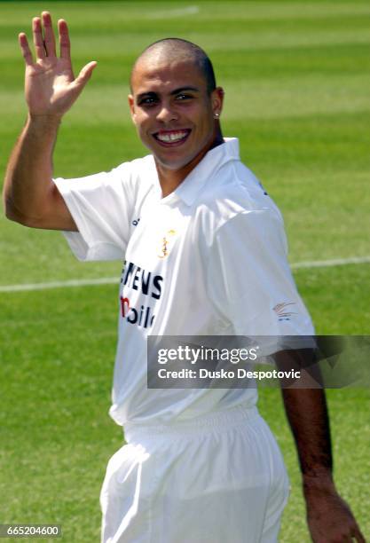 Brazilian soccer player Ronaldo waves to fans wearing his new Real Madrid shirt while being presented to the press as a new signing for this Spanish...