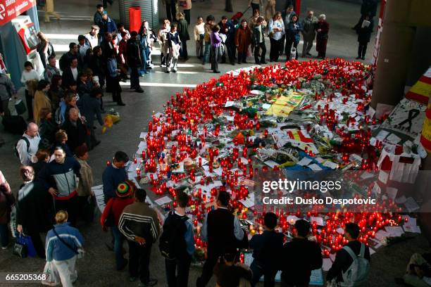 People pay tribute to the 200 victims of the March 11 terrorist attack at the Atocha train station as dozens of red candles are laid in the concourse...