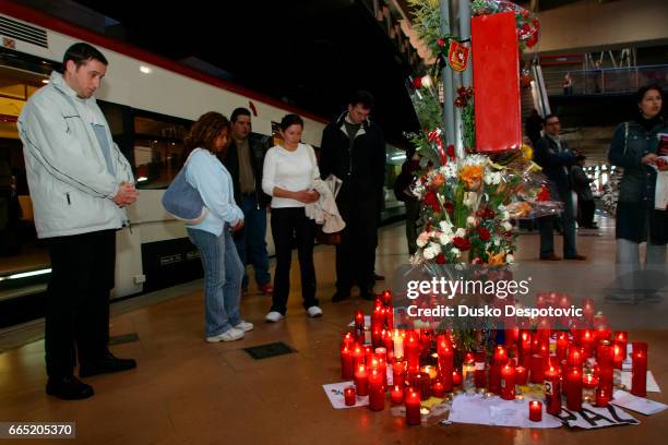People pay tribute to the 200 victims of the March 11 terrorist attack at the Atocha train station as dozens of red candles are laid on the platform...