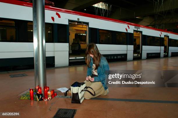 People pay tribute to the 200 victims of the March 11 terrorist attack at the Atocha train station as red candles are laid in the concourse with...