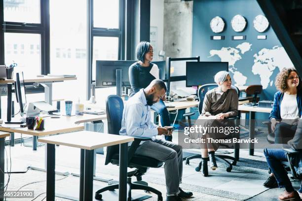 businessman checking data on smartphone during project meeting in office - to assemble world stock pictures, royalty-free photos & images