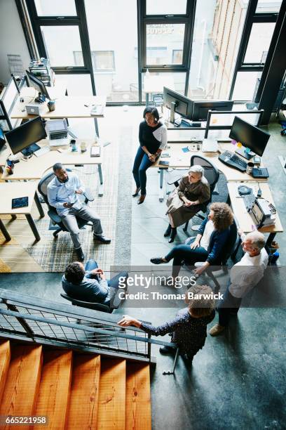 businessman leading team meeting in high tech office overhead view - big tech company stock pictures, royalty-free photos & images